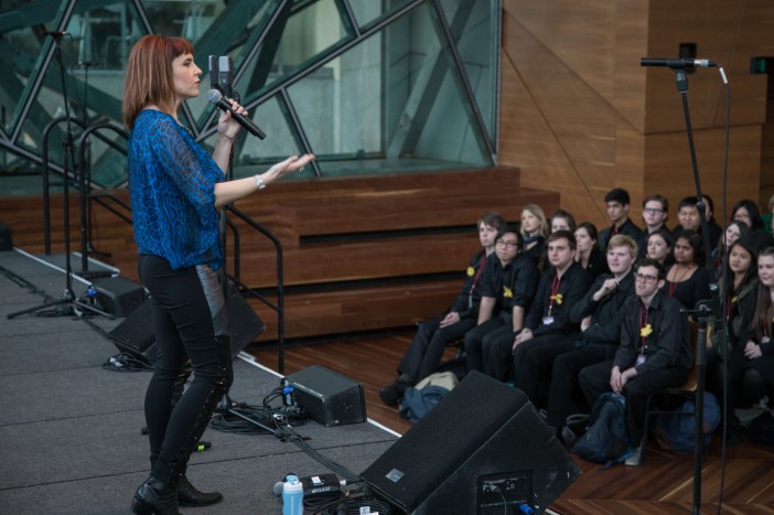 We can wear black on stage, but need to consider what will stand out from a distance. The best choice is something that visually communicates your identity.